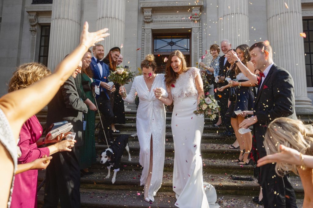 Confetti being thrown at two brides at Marylebone Old Town Hall