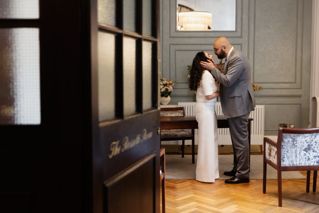 bride and groom embracing just after wedding at Chelsea Old Town Hall