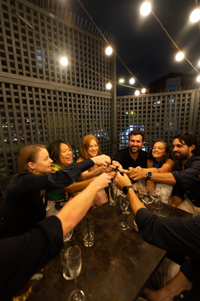 Guests cheering on pub rooftop on a summer's evening