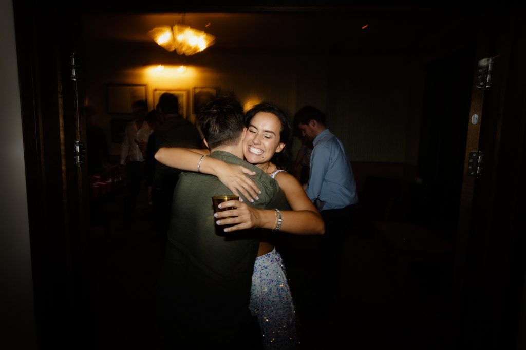 guests hugging each other at a party in London