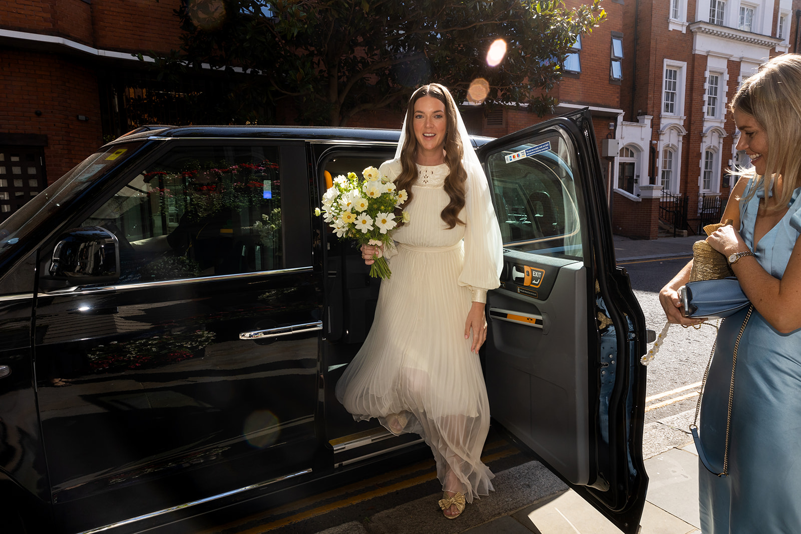 Bride arriving in black cab at Kensington and Chelsea register office.