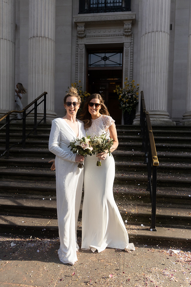 Two brides outside Marylebone Old Town Hall after their wedding.